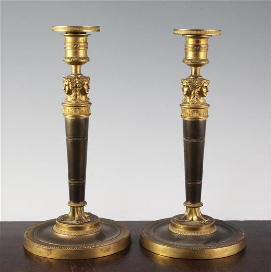 A pair of Empire style bronzed ormolu candlesticks, 10.5in.